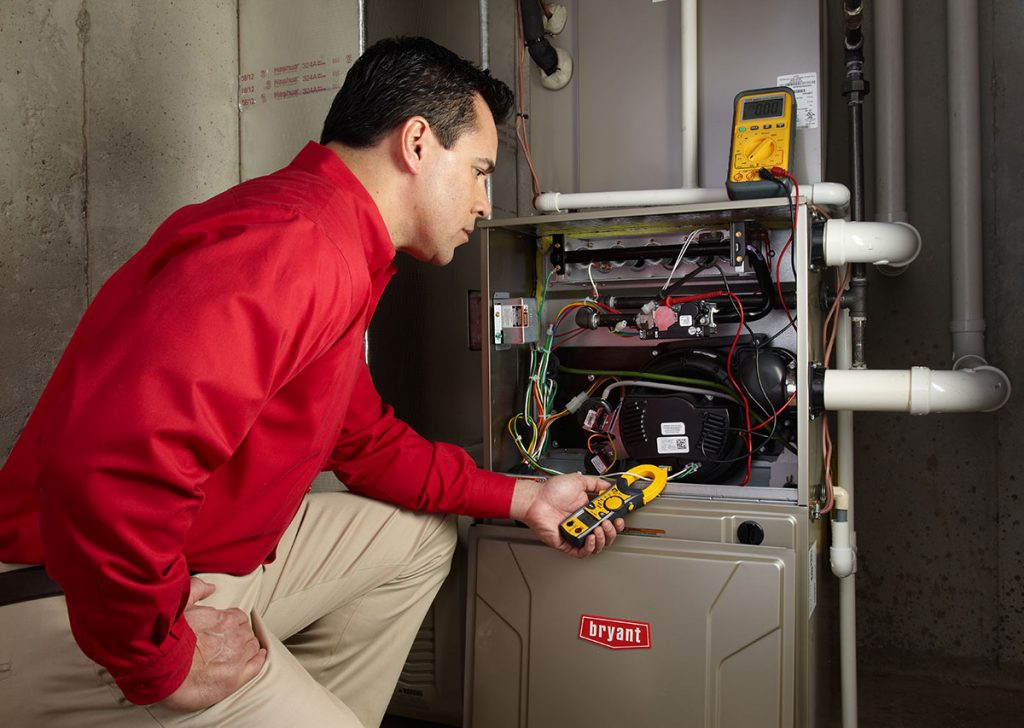 HVAC technician repairing an indoor furnace in Laveen