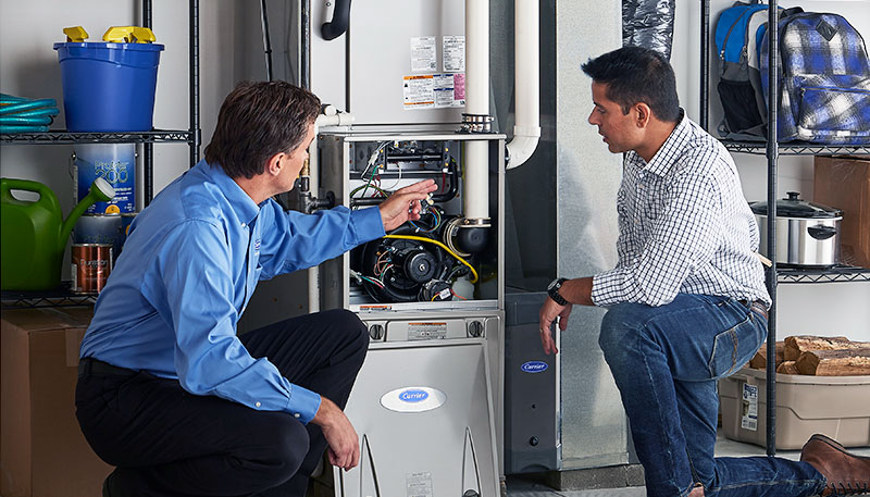 HVAC technician evaluating a furnace for repair or replacement in Laveen