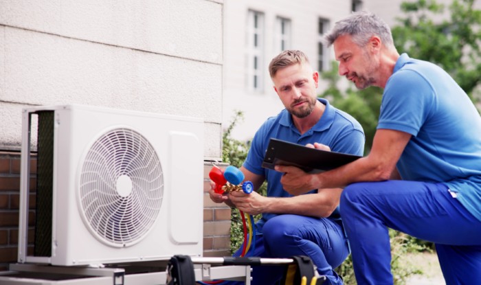 HVAC technicians installing an outdoor air conditioning unit in Laveen