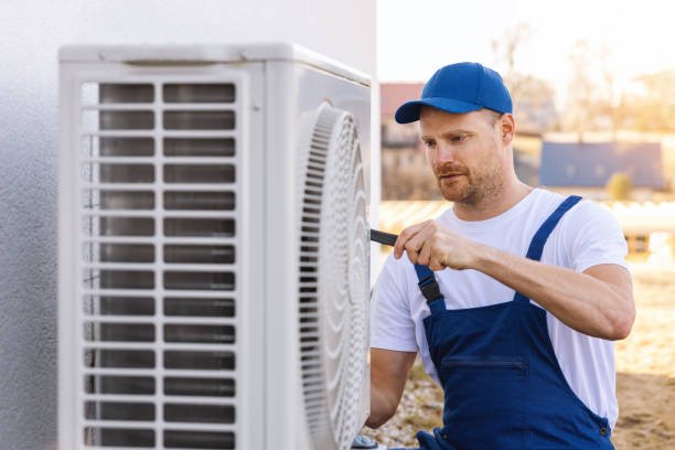 HVAC technician servicing an outdoor air conditioning unit in Laveen
