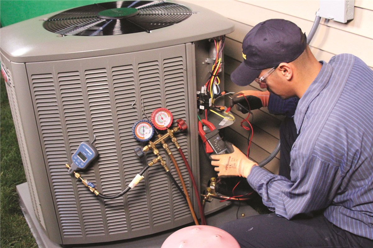 HVAC technician testing an outdoor air conditioning unit in Laveen