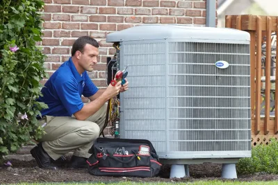 design-air-heating-and-air-conditioning-decatur-il-05 – Copy HVAC technician inspecting an outdoor air conditioning unit in Laveen, AZ