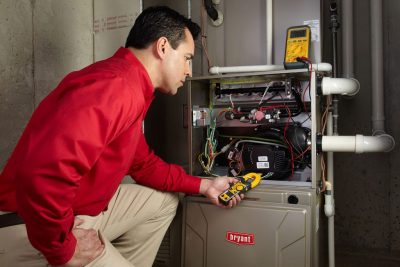 furnace repair Heating and air conditioning technician servicing an indoor furnace in Laveen, AZ